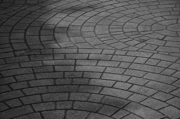 Patterned paving tiles, old cement brick floor - monochrome background