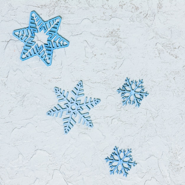 Patterned wooden snowflakes on glitter background with copy space