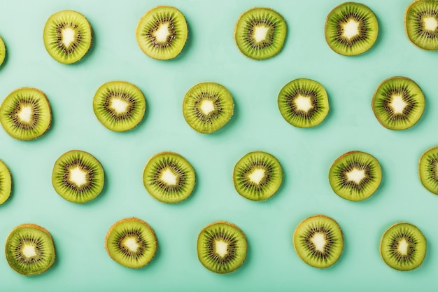 The patterns of the slices of kiwi fruit on green surface