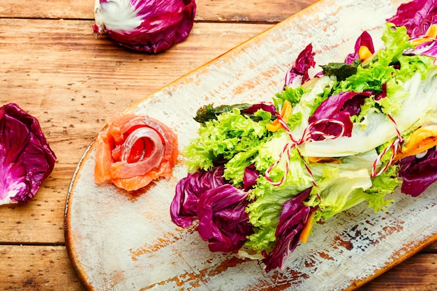 Paupiette from salad,salmon and dried apricots.Lollo rossa salad with salmon