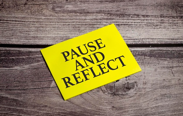 Pause and reflect the phrase on yellow paper and pen