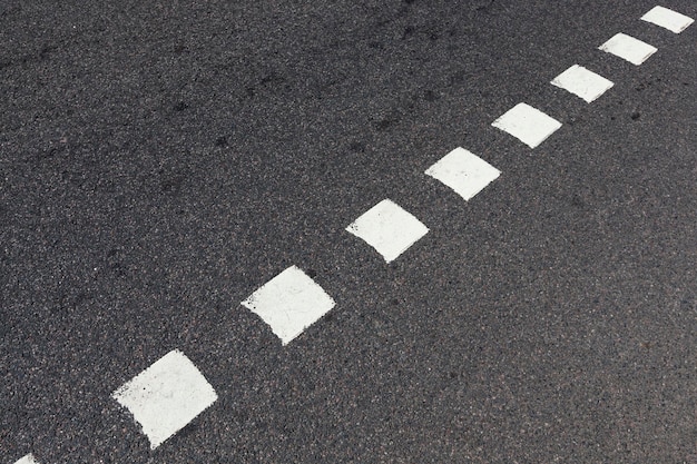 Paved road, a close-up of a part of the carriageway of an asphalt road, a road made of crushed stone, resin and other building materials