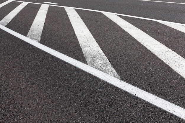 Paved road with white road markings for transport management