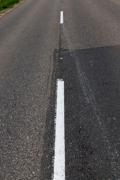 Paved road with white road markings for transport management