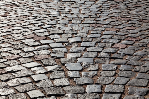 The pavement of granite cobblestones in the backlight