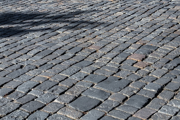 The pavement of granite cobblestones. Old city road