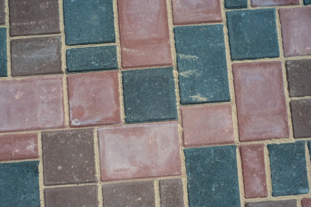 Paving slabs of different colors and shapesTexture of different colored patterned paving slabs Modern road surface