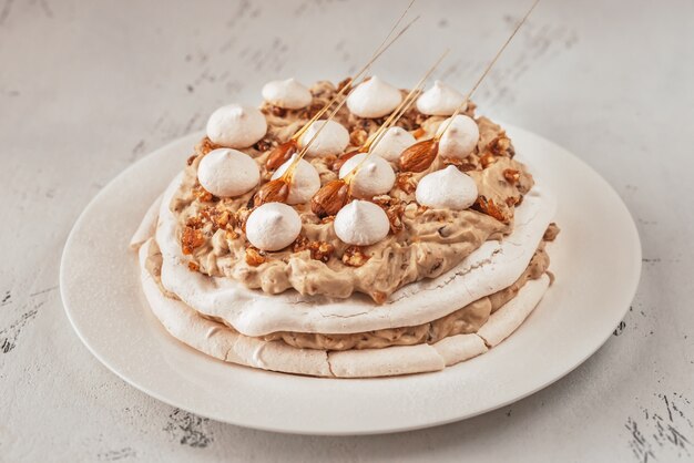 Pavlova cake with caramel and almonds