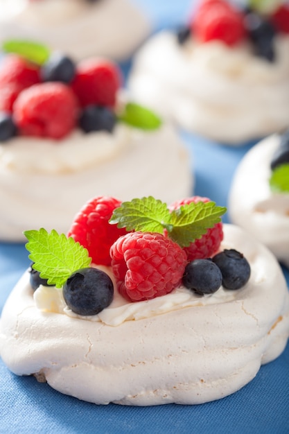 Pavlova meringue cake with cream and berry