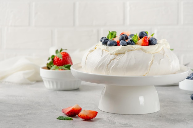 Pavlova meringue cake with whipped cream and fresh berries on top Summer dessert Copy space