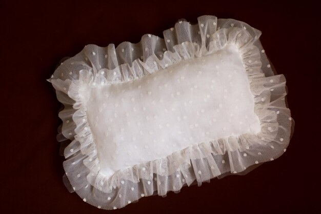 paw on a white background. pillow with lace