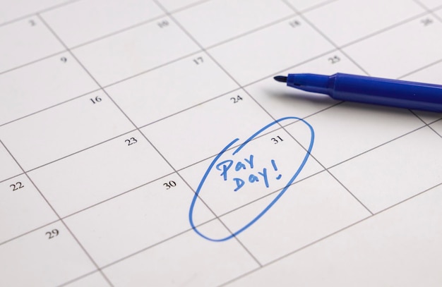 Pay day words in blue written on calendar