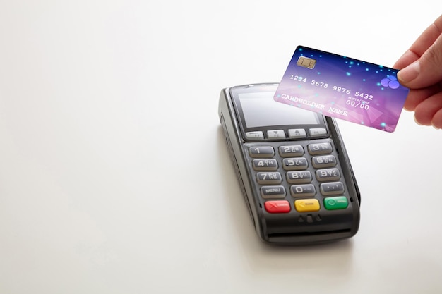 Payment machine POS terminal and credit card isolated on white background