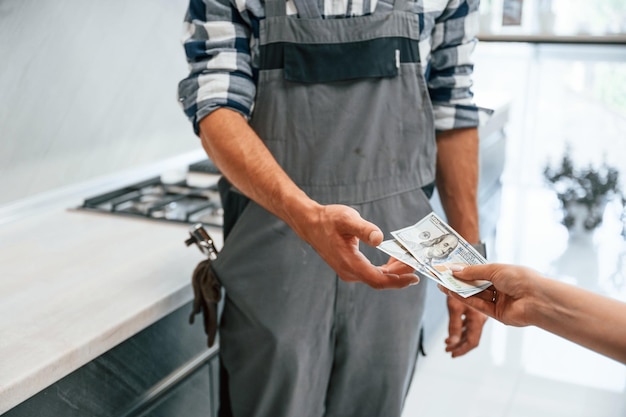 Payment for the work Close up view Plumber receiving cash