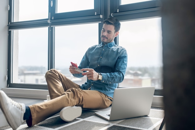 Payments online. Young man making online payment on his smartphone