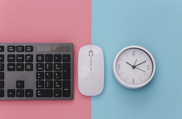 PC keyboard with pc mouse, clock on pink blue