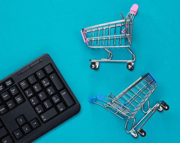 PC keyboard with supermarket trolleys on blue