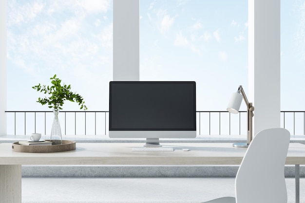 柱と大きな窓のある明るい部屋の机の上に立つPC黒いデスクトップの正面図職場とインテリアデザインのコンセプト3Dレンダリングモックアップ