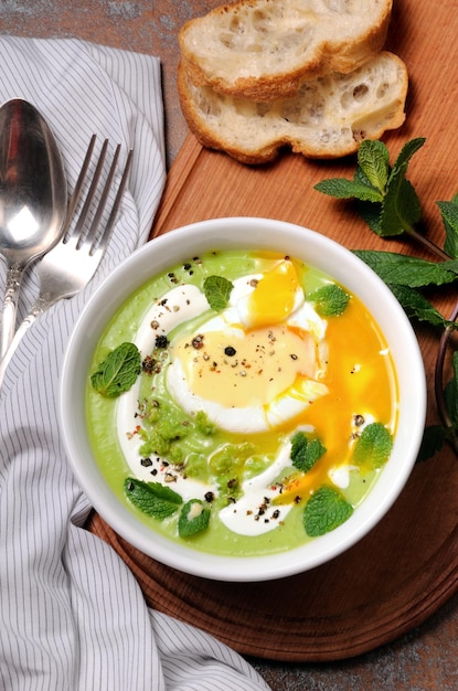 Pea puree soup with poached egg and peppermint