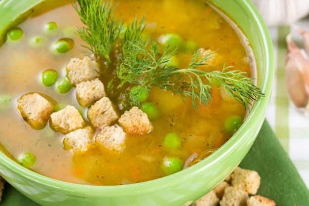 Pea soup with croutons in a tureen