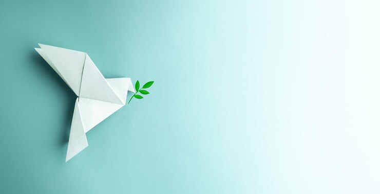Peace and Hope A white dove Flying over the Blue background Holds an Olive Branch