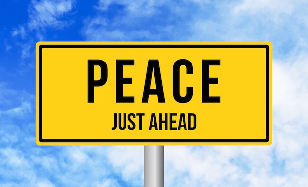 Peace just ahead road sign on blue sky background