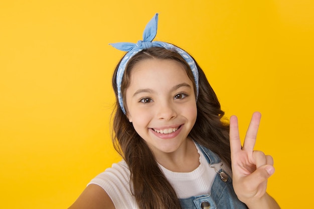 Peace Positive emotions Cheerful teen Feel happiness This how happiness looks like Happy smiling kid girl close up face Emotional expression Express happiness Emotional child concept