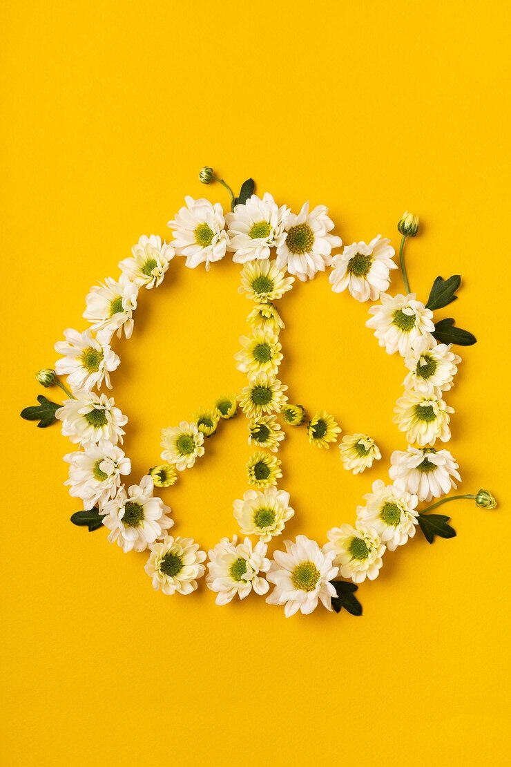 Peace symbol made of white flowers on a bright background