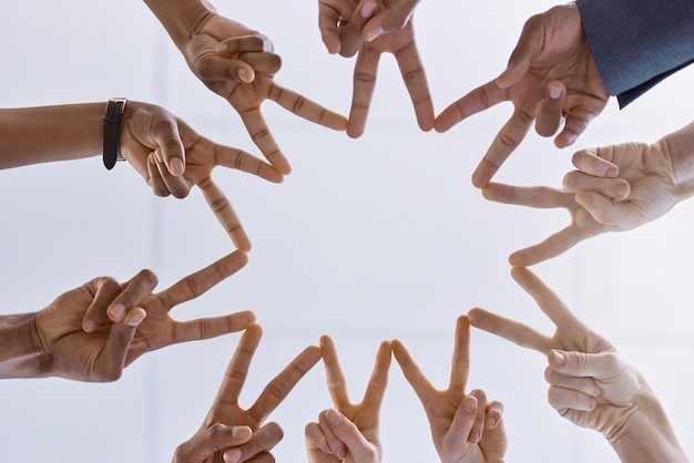 Peace teamwork and support or collaboration of business people hands or finger as symbol of their partnership and trust Diversity friends and corporate company workers making star working together