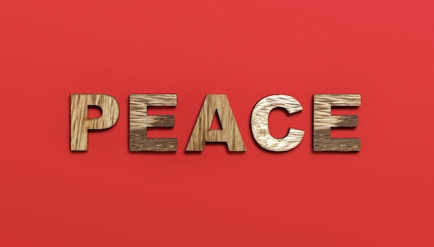 사진 빨간색 배경에 화려한 나무 알파벳으로 쓰여진 평화 단어는 끔찍한 전쟁 파괴 국가의 개념 상위 뷰 복사 공간