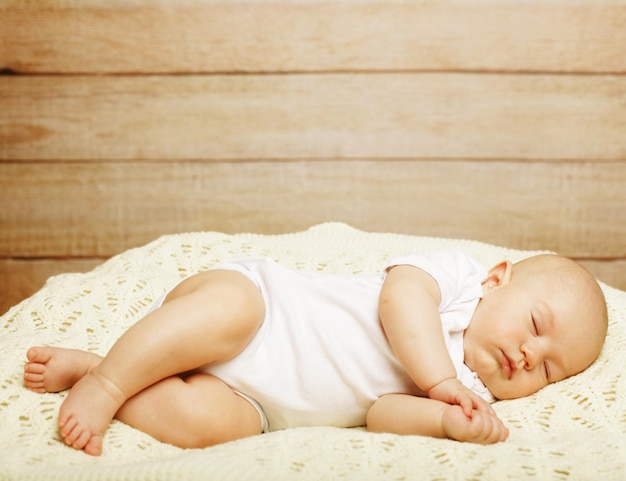 Peaceful baby lying on a bed while sleeping