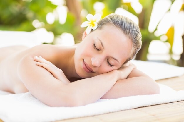 Peaceful blonde lying on towel