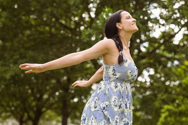 Peaceful brunette in dress standing