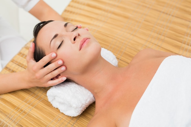 Peaceful brunette enjoying a head massage