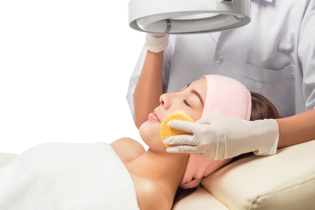 Peaceful brunette getting micro dermabrasion from beauty therapist in the health spa. 