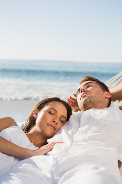 Peaceful couple sleeping in a hammock