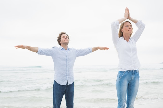 Peaceful couple with eyes closed at beach