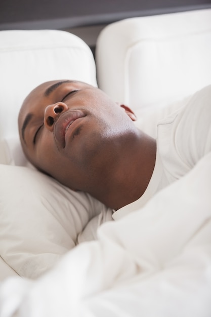 Peaceful man sleeping in bed