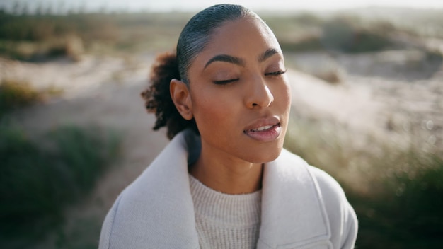 Peaceful model open eyes meditating outdoors closeup beautiful african american