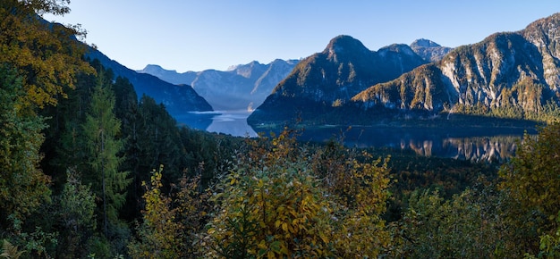 Peaceful morning autumn Alps mountain lake with clear transparent water and reflections Hallstatter lake Upper Austria