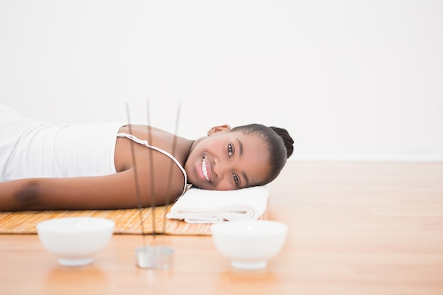 Peaceful pretty woman lying a bamboo mat 