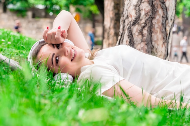 Peaceful woman listening to music with headphones outdoors