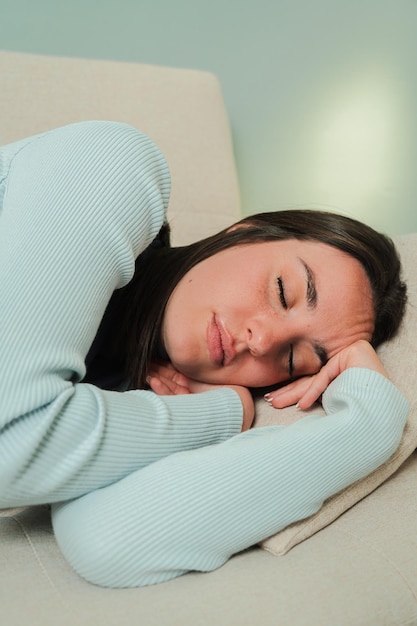 peaceful young woman resting comfortably on a soft couch embracing tranquility and serenity while