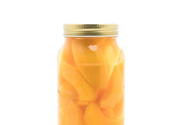 peach in bottle on white