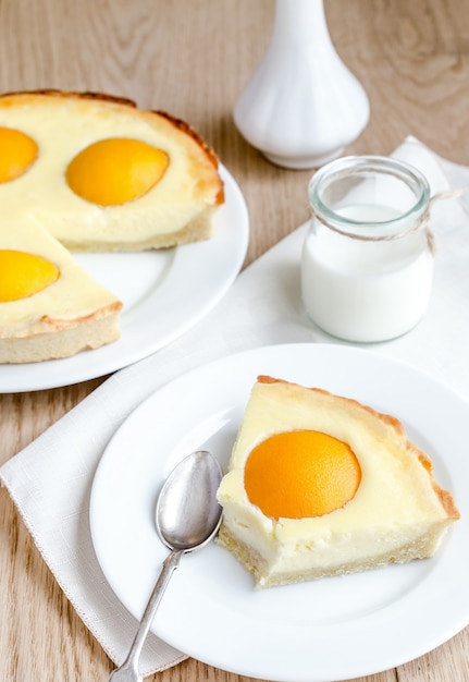 Peach and cheese tart on white plate