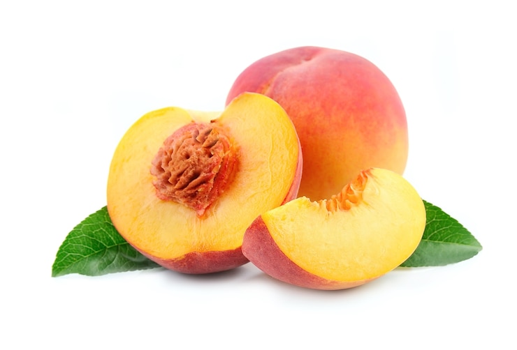 Peach fruits with leaves isolated on white
