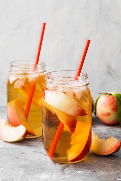 Peach ice tea on a gray background