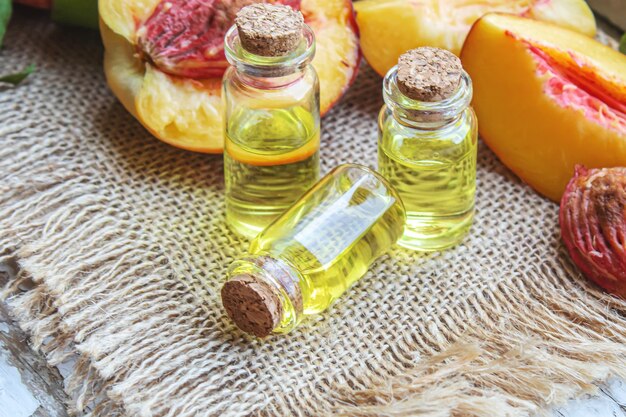 Peach seed oil in a bottle. Selective focus.