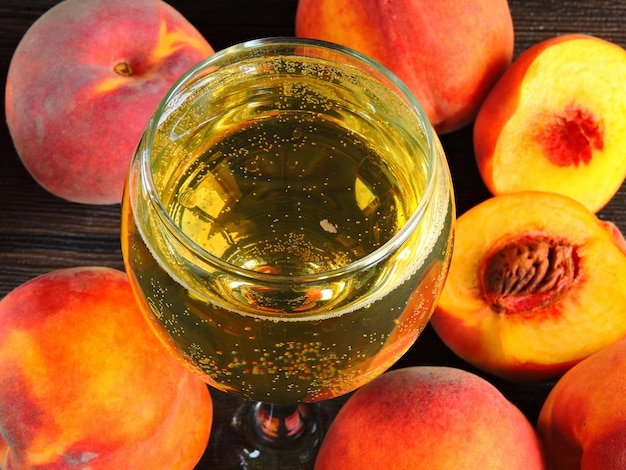 Peach wine. Fluffy peaches. Close up.