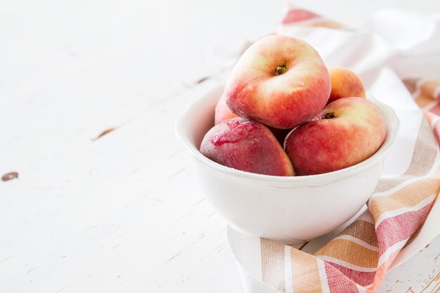 Peaches in white bowl